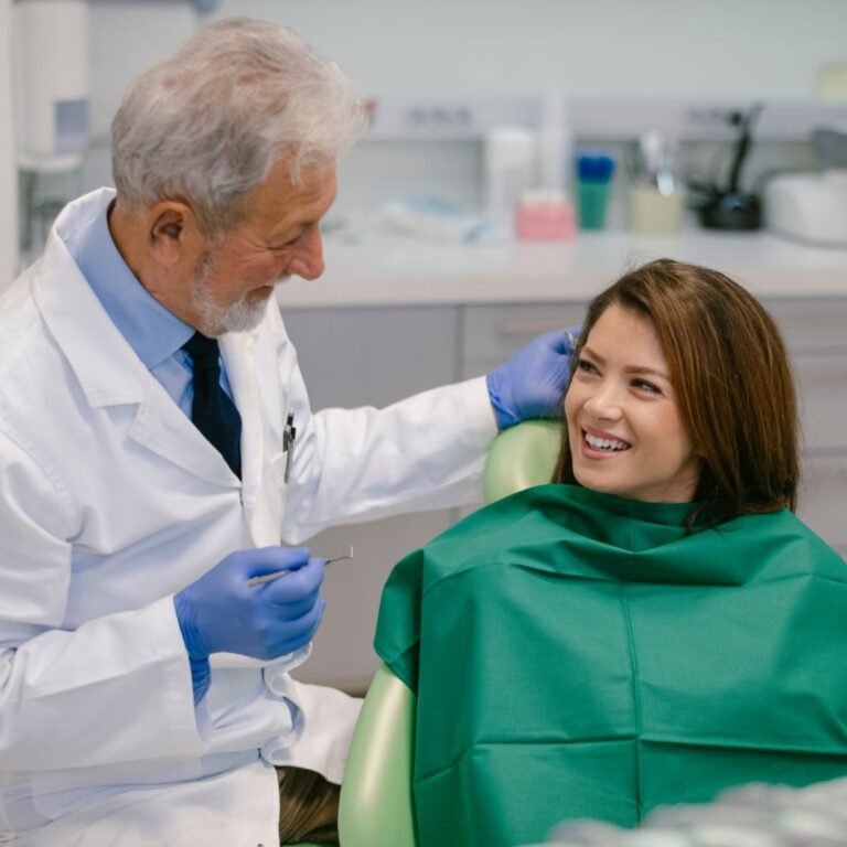 An oral surgeon does an after care exam
